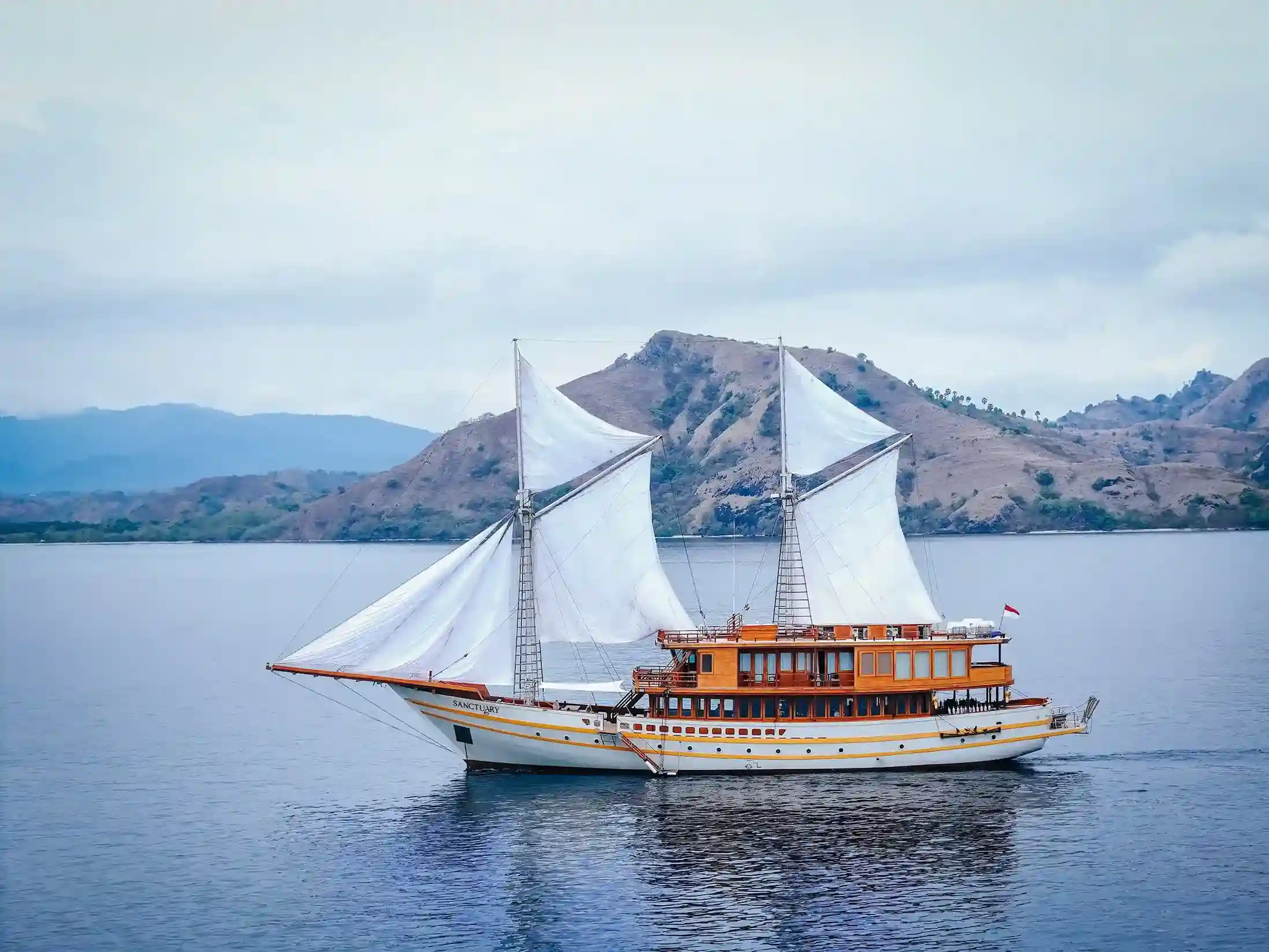 A phinisi under sail in Indonesian waters